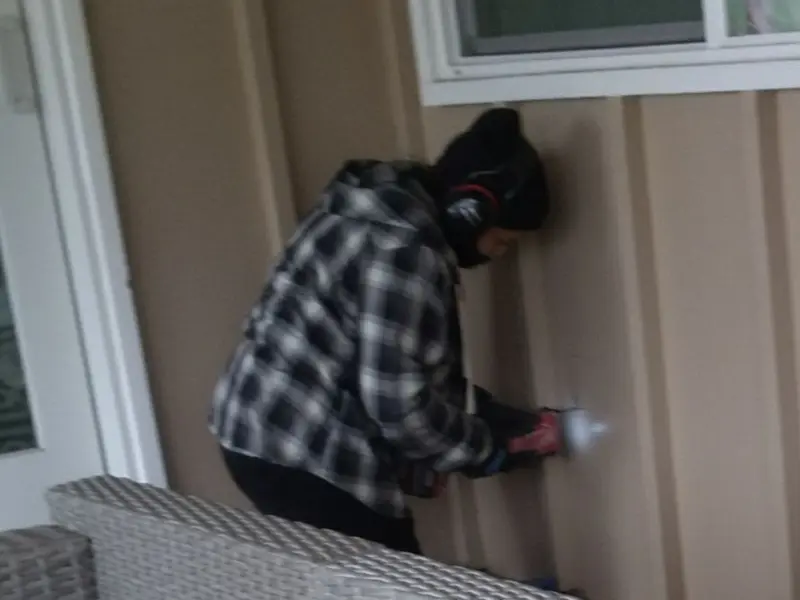 Professional electrician installing an exterior outlet in Liberty